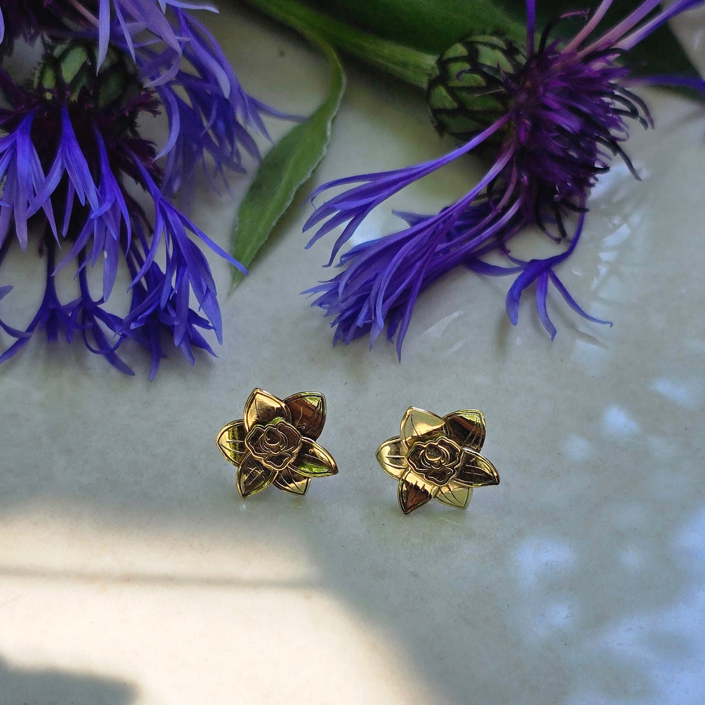 Handcrafted brass orchid stud earrings with sculpted petals and a soft matte finish, designed for a delicate botanical-inspired look