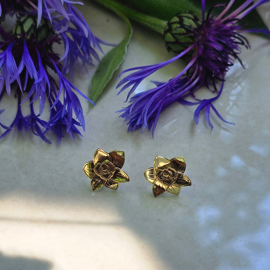 Handcrafted brass orchid stud earrings with sculpted petals and a soft matte finish, designed for a delicate botanical-inspired look