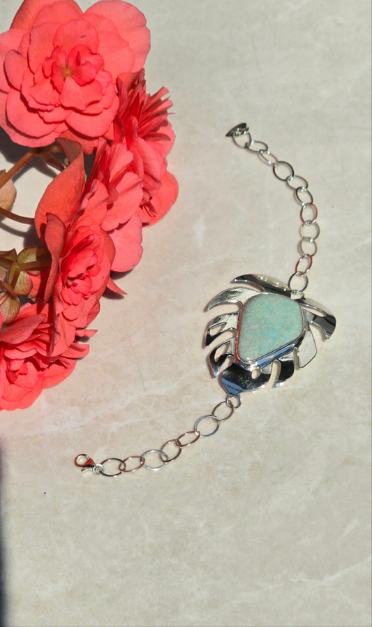 Sterling silver bracelet with large monstera leaf design and bezel-set amazonite stone on chain-link band