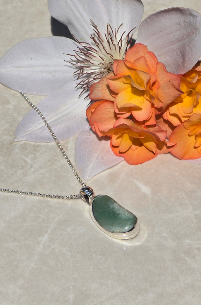 Sterling silver necklace with bezel-set green aventurine bean-shaped stone and vine-detail bail on 24-inch chain
