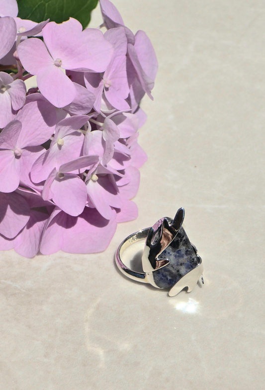 Sterling silver size 8 ring with raw tumbled sodalite stone and antler-shaped prongs wrapping around the stone