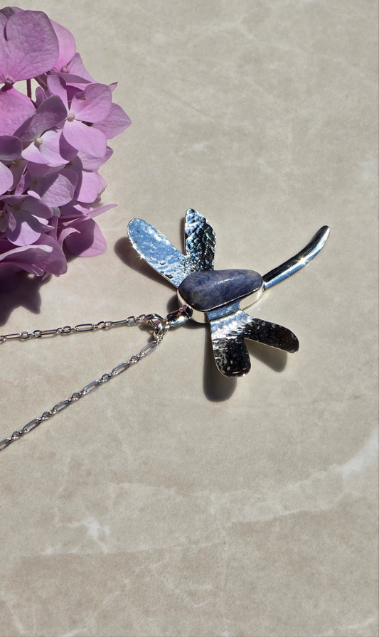 Sterling silver dragonfly necklace with bezel-set tumbled dumortierite stone body and textured wings on a 23-inch chain