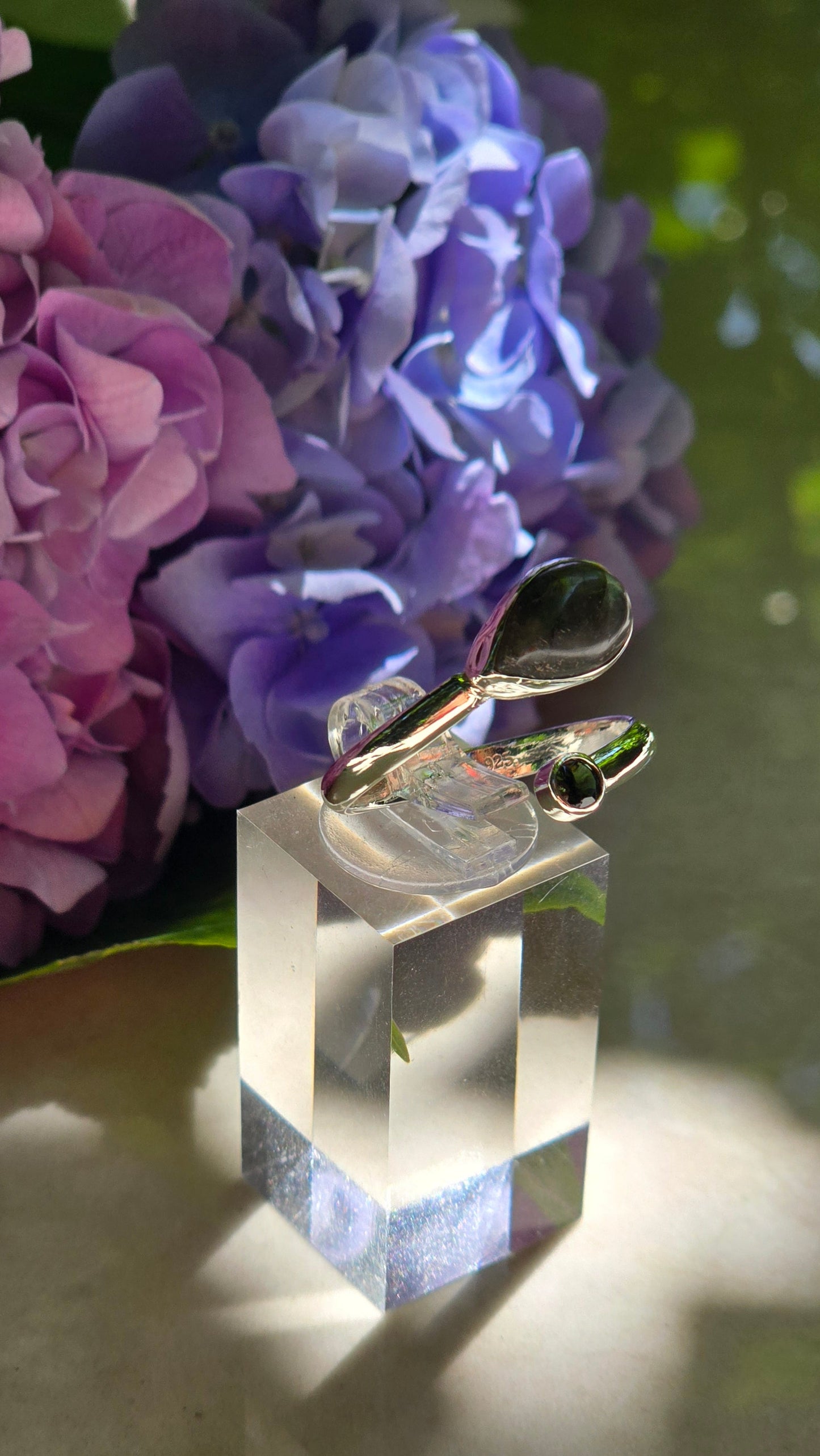 Handcrafted sterling silver river stone ring featuring a genuine bezel set labradorite and tourmaline in a flowing open band design by Vanessa Andrea Jewellery